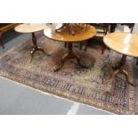 A large Persian carpet with allover floral decoration.