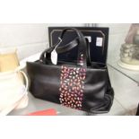 A Radley black leather handbag with dust cover.