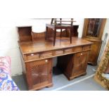 An Indian hardwood pedestal sideboard with upper section over three frieze drawers and pair of