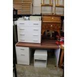 A white wood four drawer bedroom chest, a similar desk or dressing table and a bedside cupboard.