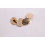 A pair of 15ct gold plain oval cufflinks.