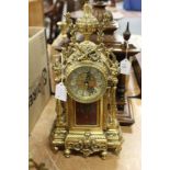 An ornate gilt metal mantle clock.