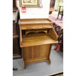 A small oak roll top desk.