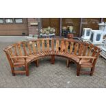 A two part semi-circular hardwood garden bench.