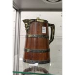 A wooden jug with plated mounts.