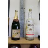A large bottle of old champagne and a Bell's whisky bottle (no contents).