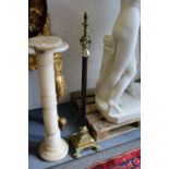 A brass Corinthian column style floor standing telescopic lamp.