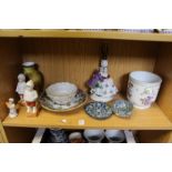 A shelf of decorative china.