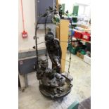 A large bronze effect figural water feature.