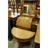 A demi-lune console table, a small oak bureau and a Victorian dressing chest.