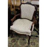 A pair of French style mahogany framed open armchairs.