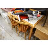 A pine, tile topped kitchen table and four chairs.