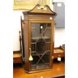 A mahogany and inlaid hanging corner cabinet.