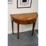 A good satinwood demi-lune foldover card table.