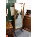 A mahogany cheval mirror.