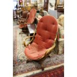 A pair of bamboo framed conservatory swivel armchairs.