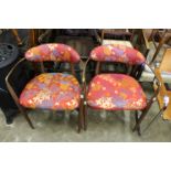 A pair of Scandinavian teak brass and upholstered armchairs.