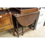 An oak drop leaf gate leg table and an oak bureau.