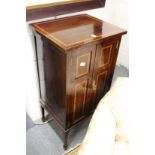 An Edwardian inlaid mahogany pedestal cupboard.