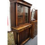 A William IV mahogany cupboard bookcase with column supports, the base with two drawers and two