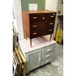 A three drawer chest and an old painted kitchen cabinet.