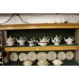 A collection of late Victorian lustre and other decorated teapots and sucriers.