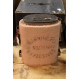 A rare warming pan for softening explosives, black japanned with pink cloth cover and stencilled