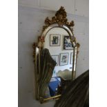 A decorative gilt framed mirror.