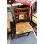A Victorian walnut metamorphic library chair with tiled inset back.
