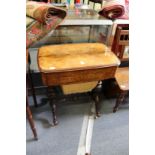 A Victorian figured walnut and inlaid work / writing table with fitted interior, on turned