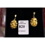 A pair of pine cone design gilt earrings.