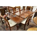 A good Victorian style mahogany extending dining table with two leaves.