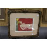 Reclining female nude in a classical decorative gilt frame. Colour print.