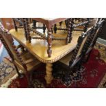 An Indian carved hardwood extending dining table with one leaf, supported on barley twist legs (made