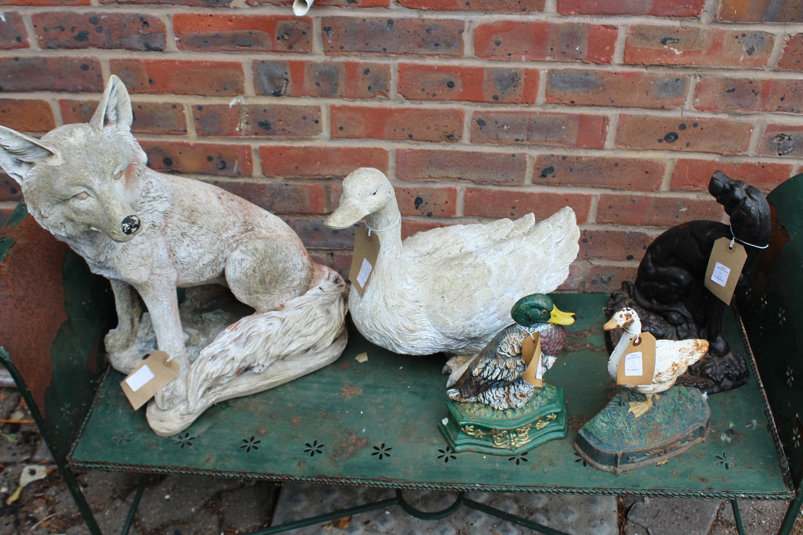 Various garden ornaments and cast iron doorstops.