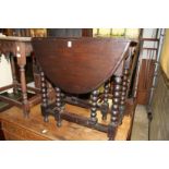 An oak drop leaf gate leg table.