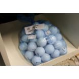 A bag of fifty Srixon soft feel golf balls.