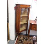 An inlaid mahogany standing corner display cabinet.