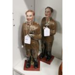 A pair of pottery figures depicting Russian military men.