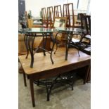 A pair of wrought iron and glass circular lamp tables together with a matching oval coffee table.