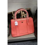 A ladies' pink leather handbag.