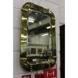 A brass framed mirror.