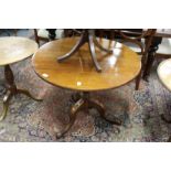 A 19th century oak circular tilt top tripod table.