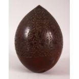 A SMALL CARVED COCONUT 'BUGBEAR', the sides carved with sailors and horsemen amongst floral