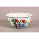 A CHINESE PORCELAIN TEA BOWL, painted with chickens, chicks and flowers, six character mark to base,