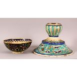 A 19TH CENTURY TURKISH KUTAHIYA BOWL, together with a similar candlestick, the bowl painted with