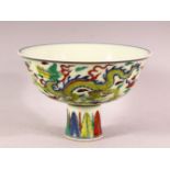 A CHINESE DOUCAI DECORATED PORCELAIN STEM BOWL - decorated with dragon interior, repeated exterior