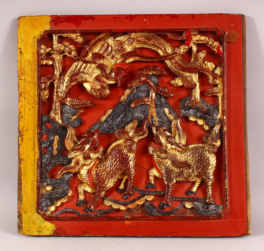 AN UNUSUAL CHINESE LACQUERED CARVED WOOD PANEL, the panel carved with kylin and phoenix, possibly