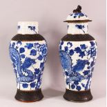 TWO 19TH CENTURY CHINESE BLUE & WHITE PORCELAIN VASES & ONE COVER, the body of the vases decorated