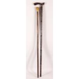 TWO WOODEN INDIAN WALKING STICKS - the larger with white metal and gilt inlaid decor, 93cm high, the